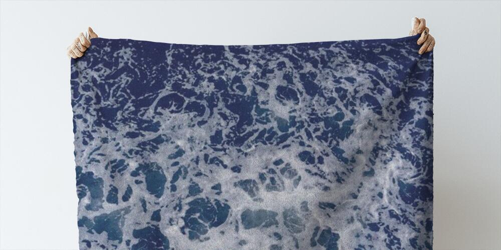abstract texture of sea white foam on a blue background of sea water, 