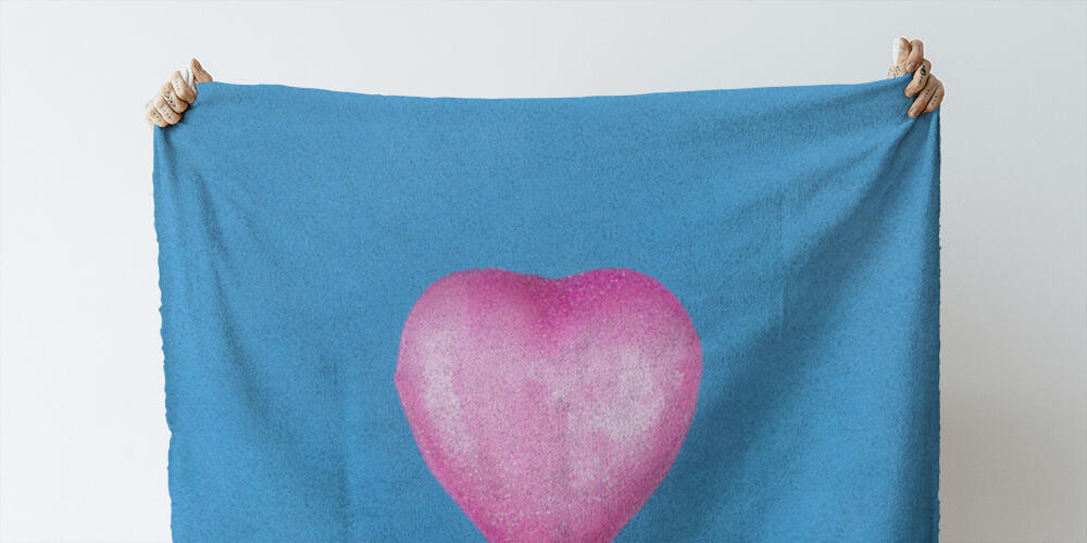 Heart dipped in pink paint on blue textured background, 