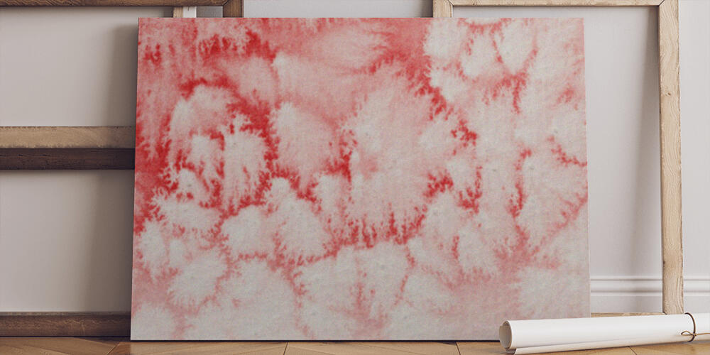 close up view of red watercolor paint spill on white paper background, 